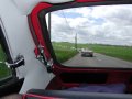 Intrieur d'une MGB GT, avec au fond 23 MG sur une route ensoleille ! Cliquez pour agrandir et la voir en grand, 800 par 600, 65 kilo-octets seulement